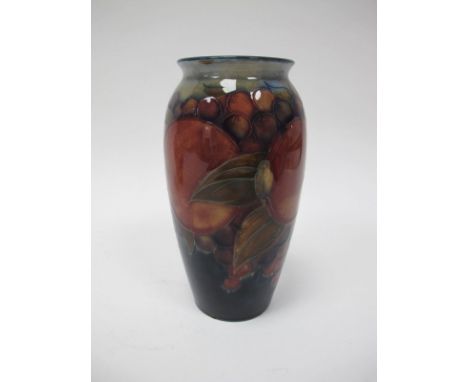 A William Moorcroft Ovoid Pottery Vase, painted in the 'Pomegranate' pattern on a deep blue ground shading to light blue at t