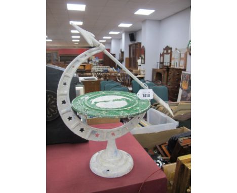 A Mid XX Century Cast Iron "Moon Dial", a semi circular arc with star shaped insets supporting a green painted plaque with tw