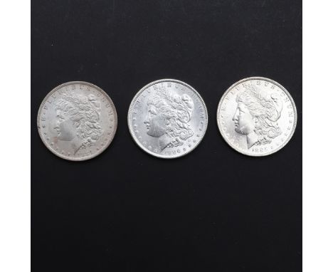 Three United States of America Morgan Dollars, 1884 (O), 1885 (O), and 1886. 3 coins. *CR Light surface marks only.