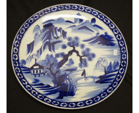 Chinese hand painted ceramic platter painted blue and white landscape decoration, (diameter 37cm approx).
