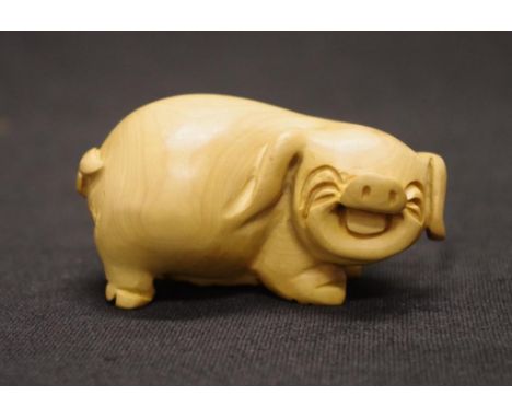 Japanese boxwood netsuke of a laughing pig length approx 7.5cm