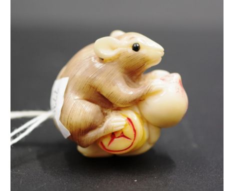 Japanese carved feasting rat netsuke signature to plum, 4cm height approx.