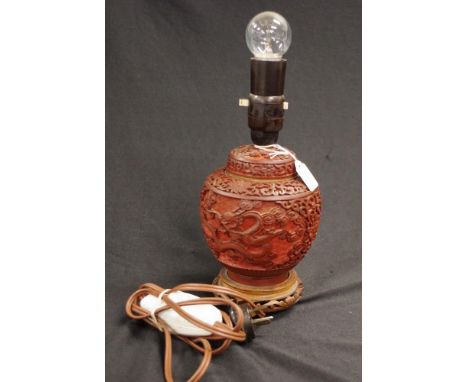 Chinese cinnabar base electric table lamp base with carved cinnabar decoration, (height 25cm approx).