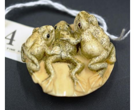 Japanese carved frogs on lily pad netsuke signature to base, 5cm length approx.