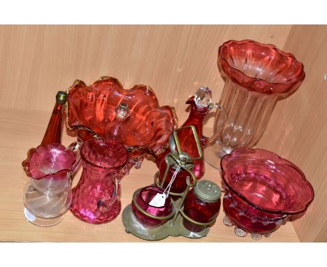 A GROUP OF VICTORIAN CRANBERRY GLASSWARE, comprising a silver plate four piece cruet set, two small cream jugs, a small vineg