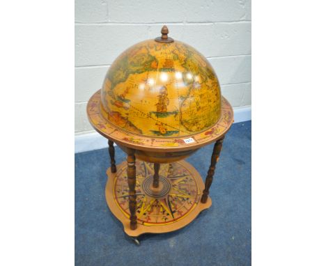 A MID TO LATE 20TH CENTURY DRINKS GLOBE, with a lid that's enclosing a fitted interior, on four turned uprights, and casters,
