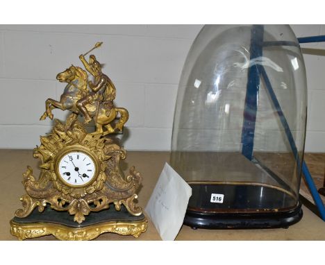 A CONTINENTAL GILT METAL MANTEL CLOCK AND A GLASS DOMED CASE, the clock flanked by a crowned soldier in battle astride a hors
