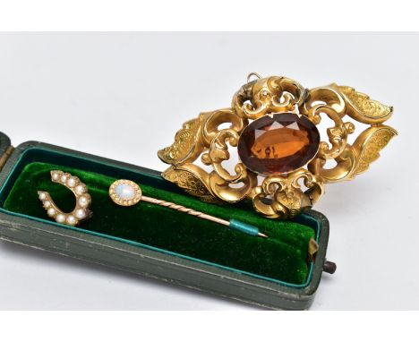 A LARGE YELLOW METAL BROOCH AND A STICK PIN, the brooch of a marquise form, decorated with scrolls and foliate patterns, set 