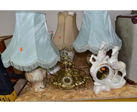 A GROUP OF CLOCKS AND LAMPS, comprising a pair of onyx table lamps with green fringed shades, height to top of fitting 33cm, 