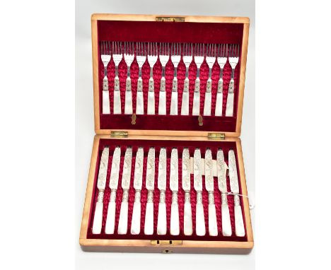 A CASED SET OF TWELVE DESSERT KNIVES AND FORKS, each EPNS blade is decorated with a floral pattern, collars have vacant carto
