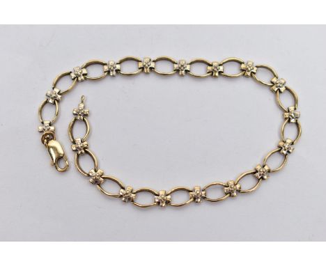 A 9CT GOLD DIAMOND BRACELET, designed with a series of oval openwork links, interspaced with cross links each set with a sing
