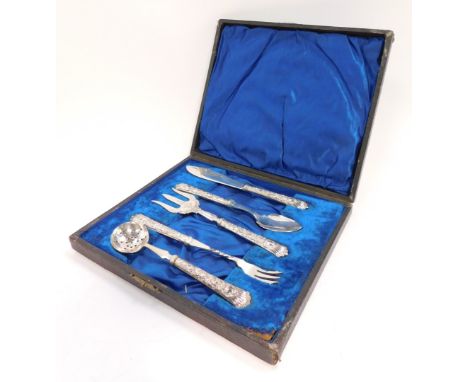 A George V silver handled serving set, with embossed rococo scroll and foliate decoration, cased, comprising butter knife, ja