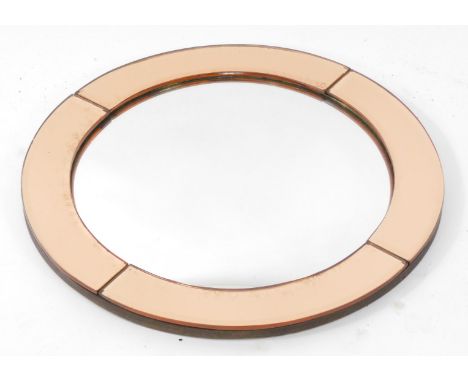 A 20thC convex wall mirror, with pink bevelled mirrored surround, 39cm diameter.