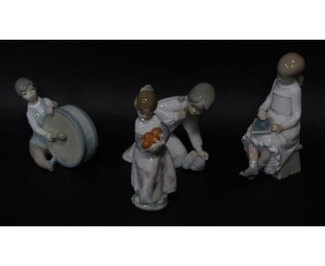 Four Lladro figures of children, three marked Lladro, child with chalk board, unmarked, the tallest figure 19cm high.