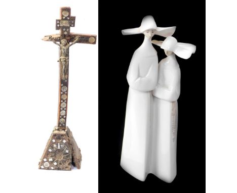 A Lladro porcelain figure of two nuns, together with an antique Continental wooden memorial cross, each 33cm high. (2)