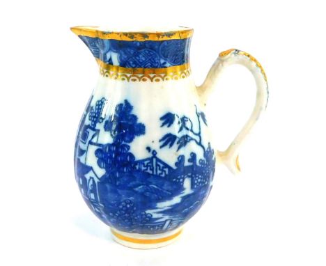 A Caughley late 18thC porcelain cream jug, having gilt and blue printed rim with sparrow beak spout, above a fluted main sect