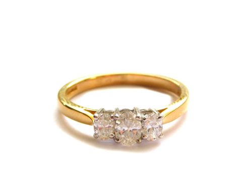 An 18ct gold and diamond three stone ring, set with oval cut diamonds, approx 0.4cts, size M, 2.9g.