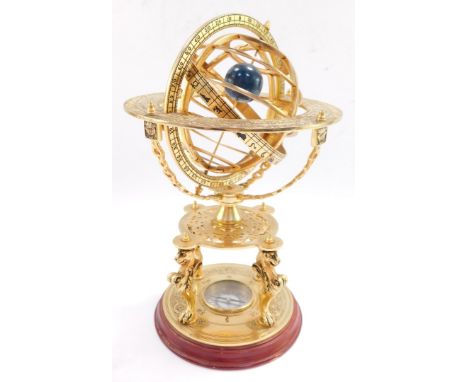 A brass orrery, with an astrological plate, raised on four supports above a table type base on three lion's paws supports, ab