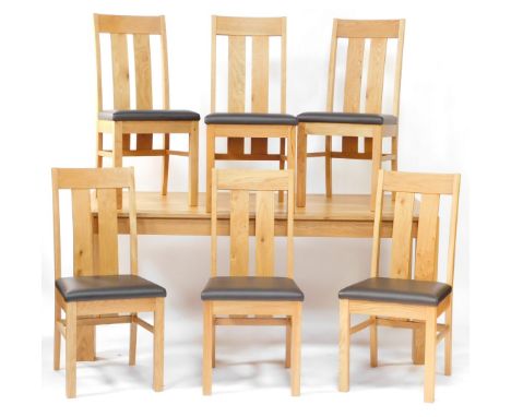 A modern light oak extending dining table, on square section legs, with extension leaves to each end, with a set of six dinin