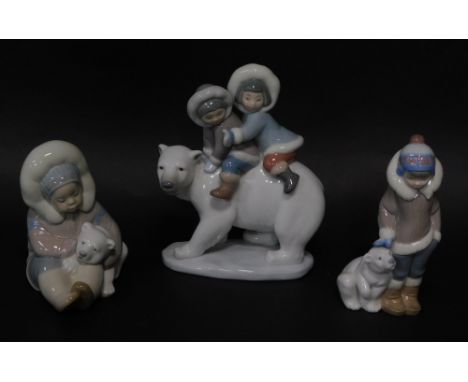 Three Lladro porcelain figures of Eskimo children with Polar bears, the tallest 18cm high.