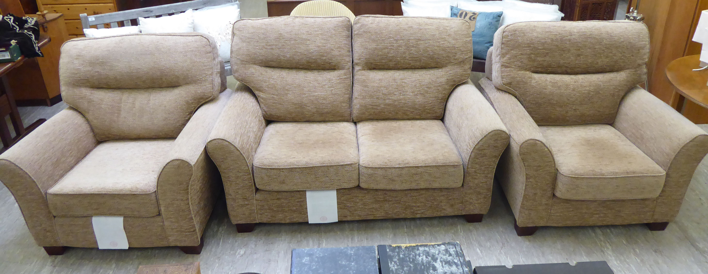 A GPlan three piece suite comprising a two seater settee and two