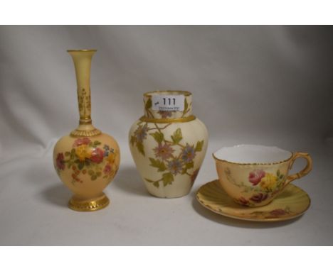 Three pieces of Royal Worcester including tea cup and saucer, scalloped vase with hand painted floral scenes and a blush ivor