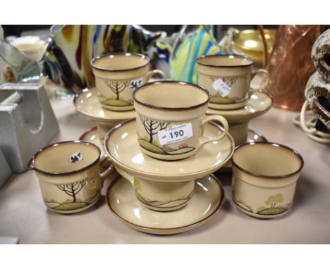 A selection of Denby Savoy tea cups and saucers with milk jug