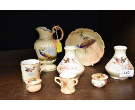 A selection of fine Royal Worcester ceramics including miniature love cup, song bird decorated vase pair and Peacock decorate