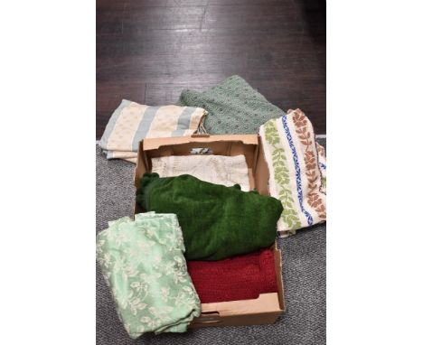 An assortment of vintage curtains, throws and fabrics, various eras and styles.