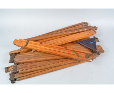 Wooden Camera Tripod Components, comprising fifteen approx assorted tripod legs, seven approx support plates, one marked Newm