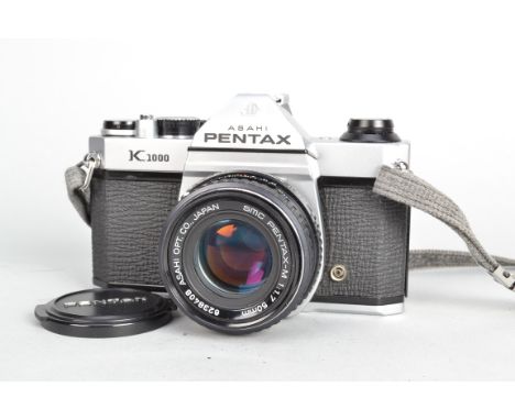 An Asahi Pentax K1000 Camera, serial no 7560381, shutter working, meter responsive, body G, light marks, with SMC Pentax-M 50