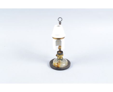 A late 19th Century lacquered brass and iron Microscope Lamp,  with glass reservoir and white ceramic diffuser, in wooden cas