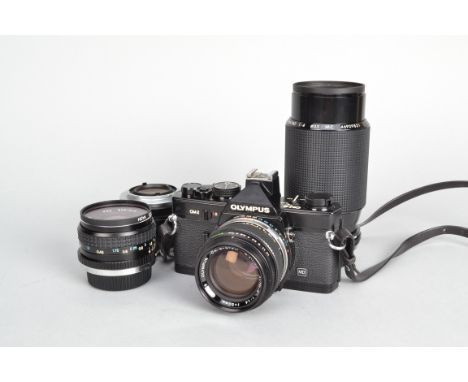 An Olympus OM2 MD Camera Outfit, black, serial no 390735, shutter working, meter responsive, timer working, body G-VG, light 