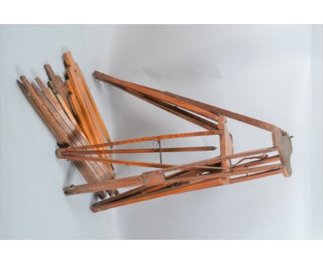 Two Wooden Tripods, with triangular platforms, folding legs and a quantity of loose tripod legs 