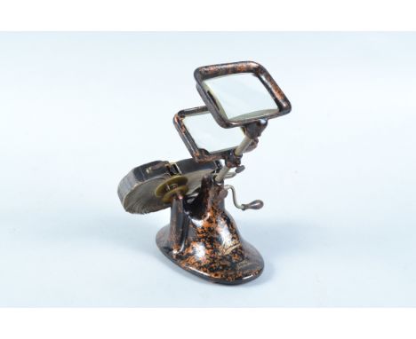 An early 20th Century cast-iron simulated-tortoiseshell Hand-Crank Kinora Paper Film-Reel Viewer,  with reel no. 70, performi