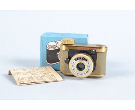 A Grey-Gold Petie Subminiature Camera, supplied by Walter Kunik of Frankfurt, VG, shutter working, Achromat 25mm f/9 lens, wi