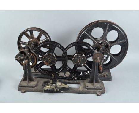Cinema Projectionist Film Handling Equipment, including two pairs of 35mm film rewinds, mounted on portable stands, four 35mm