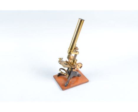 A late-19th Century lacquered and anodised brass Student's Compound Monocular Microscope,  with eyepiece, objective, simple s