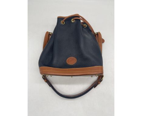 Dooney & Bourke Drawstring Navy and British Tan Pebbled Leather Shoulder Bucket Bag Purse. 
No further descriptions, photogra