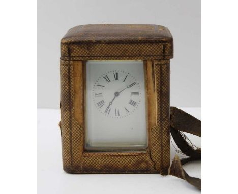 A late 19th century French brass framed carriage clock, the white enamel dial, with Roman numerals, the backplate engraved "R