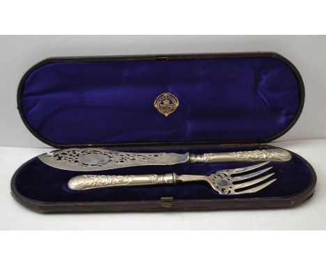 Martin Hall and Co, a silver bladed fish serving knife and fork, decoratively pierced and embossed, handles crested with a mo