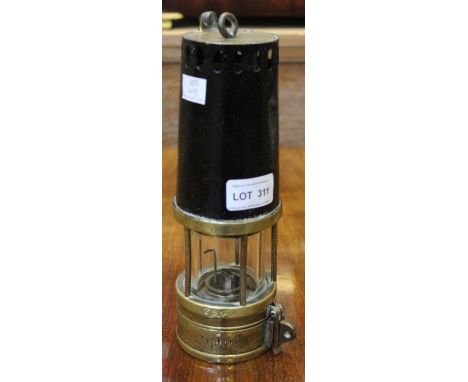 An original brass based miners lamp by Richard Johnson of Manchester &amp; Liverpool, having various impressed numbers