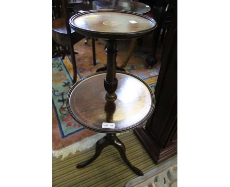 A reproduction mahogany finished circular two tier table on tripod base, 75cm high