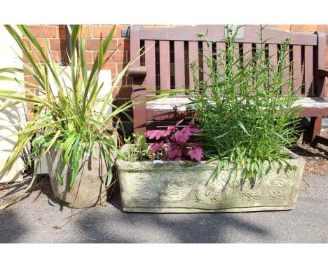 An ornate rectangular trough planter with contents, plus a round planter with contents