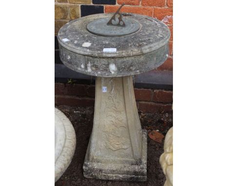 A stone sundial on non matching plinth