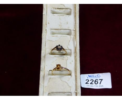 A 9ct gold ring mounted with a cluster of dark blue stones and diamond chip to centre, plus another 9ct gold ring with amber 