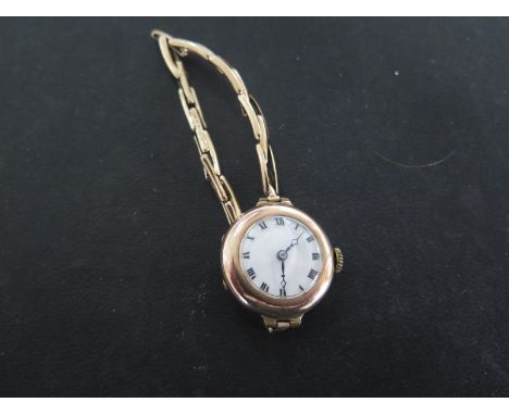 A Ladies 9ct Yellow Gold Wristwatch, Roman numerals to white enamel dial - running in saleroom 