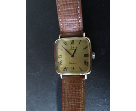 A Gents Omega Geneve wristwatch - manual wind with square gold plated case on leather straps - the gold tone face with Roman 