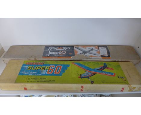 A Keil Kraft super 60 aircraft model kit and a junior 60 aircraft model kit
