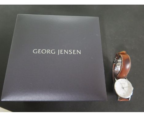 A Henning Kopel dual time Georg Jenson watch, white enamel dial, date aperture at 6 O'clock, dot hour markers, centre sweep s